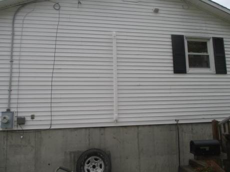 white duct on exterior wall